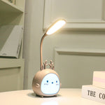 Cute lamp with a face on a table against a neutral background