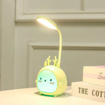 Children's night light with deer design on a surface with books in the background