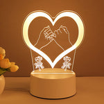Heart-shaped night light with hands holding a flower and roses on a brown background