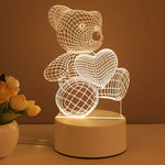 Teddy bear-shaped night light on a brown surface with flowers in the background