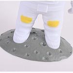 White socks with yellow accents on a textured gray platform