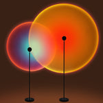 Two standing lamps with colorful circular lights on a dark background