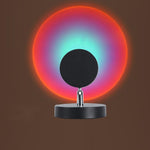 Colorful circular light with a black center on a dark background