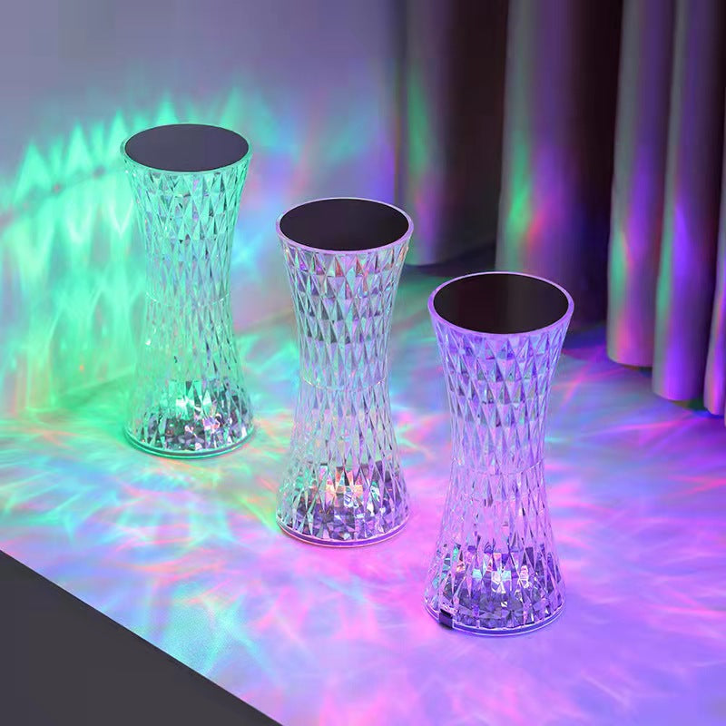 Three illuminated stools on a reflective surface with colorful lighting effects.