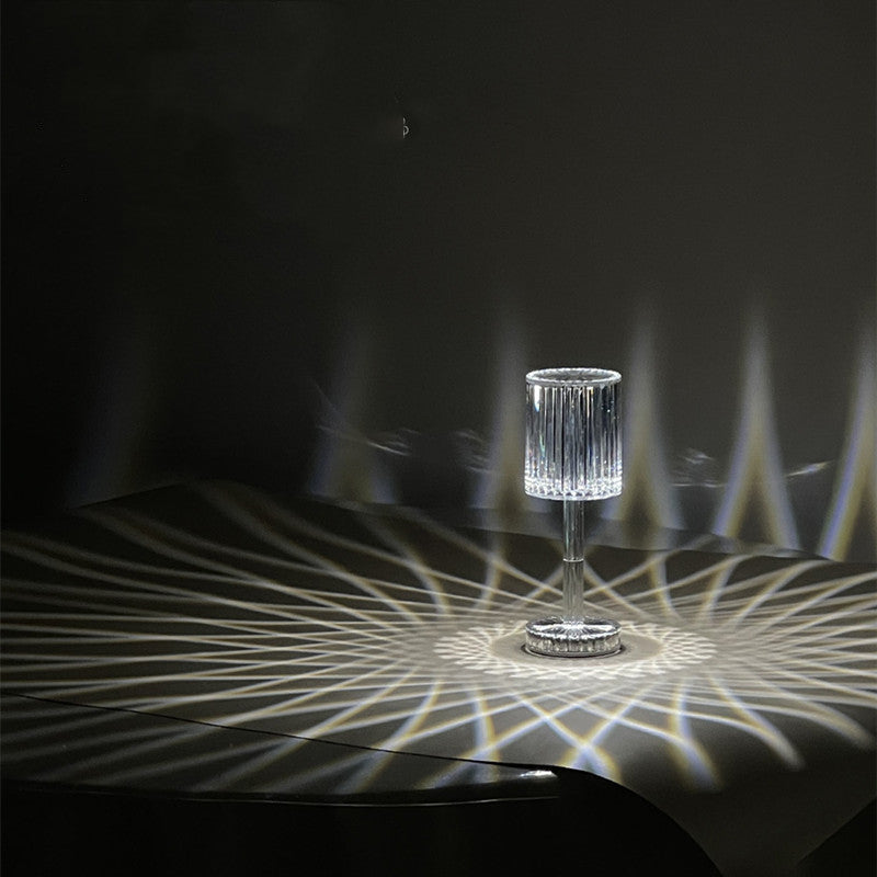 Crystal glass with light projection on a dark surface