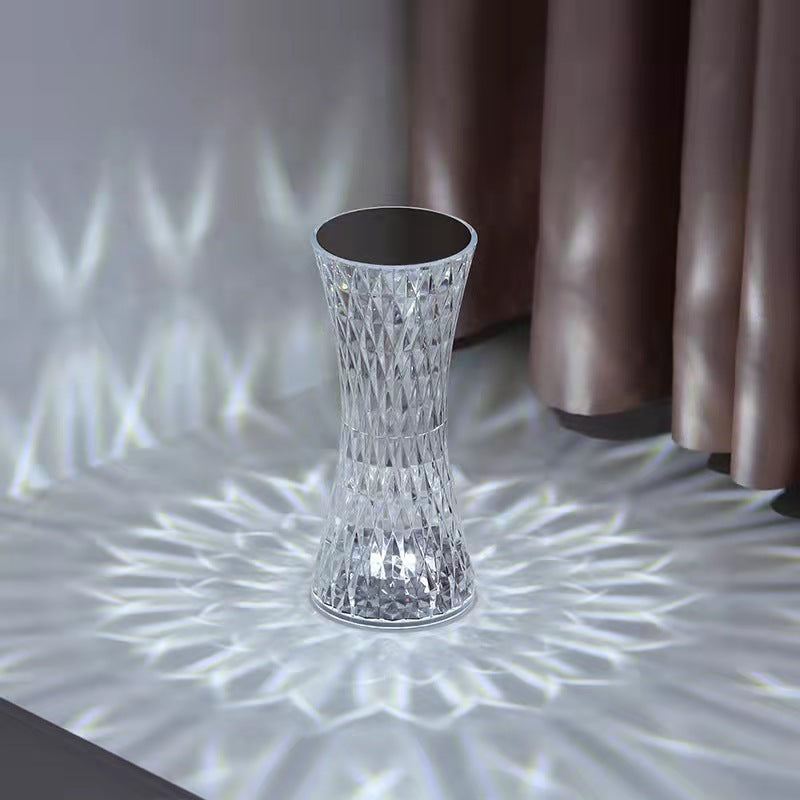 Decorative crystal vase on a textured surface with a blurred background