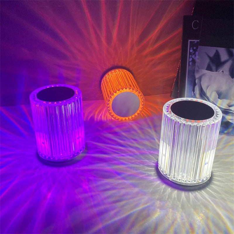 Three colorful LED lights on a reflective surface with vibrant light patterns.