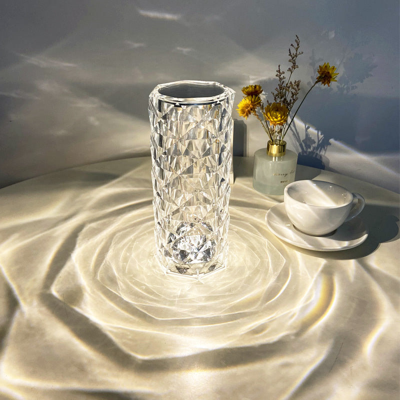 Clear textured glass vase on a textured surface with a soft light background