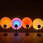 Four spherical lamps with different colored lights on a dark background