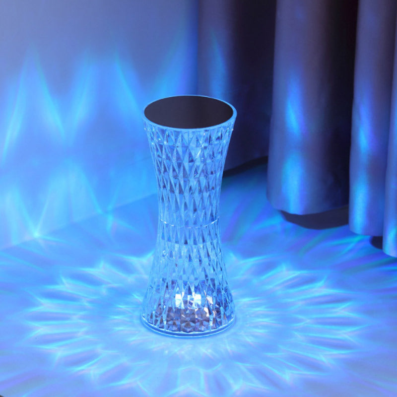 Crystal-like stool with geometric pattern on a reflective surface with blue lighting