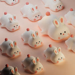 Pattern of cute cartoonish rabbit figures on a pink background