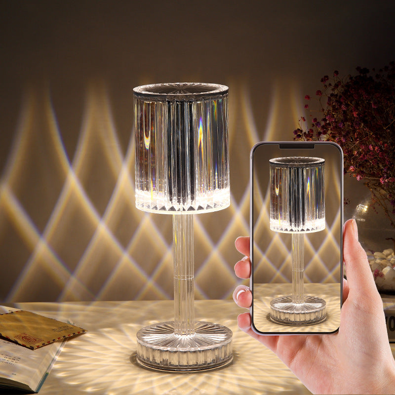 Silver lamp on a table with a hand holding a phone showing an augmented reality view of the lamp.