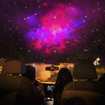 Car interior with a starry sky projection on the ceiling.