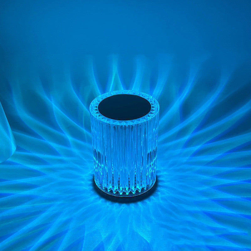 Crystal-like cylindrical object with blue light effects on a blue background