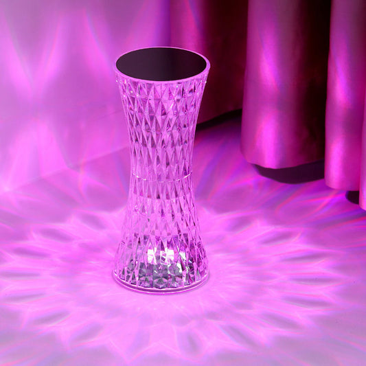 Transparent cylindrical table with a diamond pattern on a purple textured surface